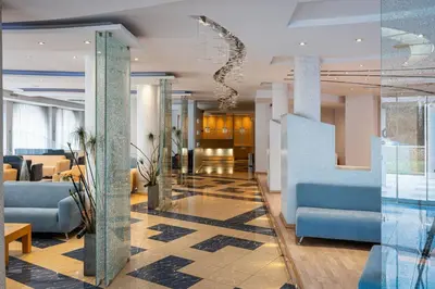 a lobby of a hotel with blue furniture at Kreoli Suites Glyfada in Athens