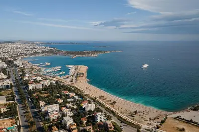 an aerial view of a beach with a boat in the water at Kreoli Suites Glyfada in Athens