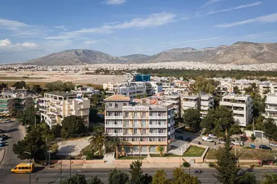 an aerial view of a city with buildings and mountains at Kreoli Suites Glyfada in Athens