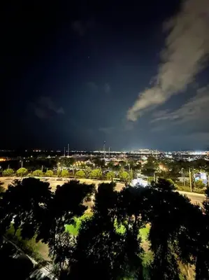 a view of a city at night with trees at Floisvos Penthouse Oasis in Athens