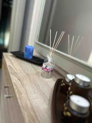 a table with three candles on top of a window at Frankie's House in Athens