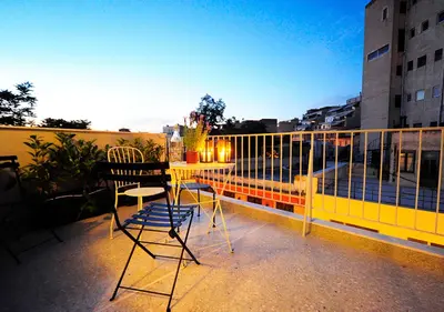 a balcony with a table and chairs on a balcony at Live in Athens, PSYRRI Central Apartments in Athens