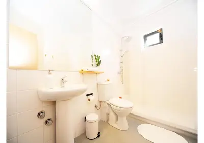 a white bathroom with a toilet and a sink at Live in Athens, PSYRRI Central Apartments in Athens