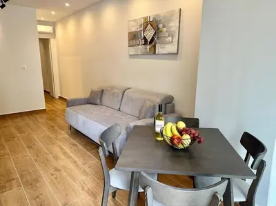 a table with a bowl of fruit and a couch at Relax Home In Moschato 2 VIPGreece in Piraeus