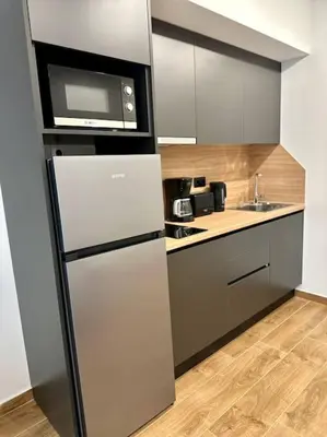 a kitchen with a refrigerator and a microwave at Relax Home In Moschato 2 VIPGreece in Piraeus