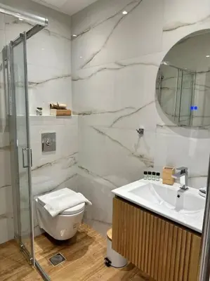 a bathroom with a toilet and a sink and a mirror at Relax Home In Moschato 2 VIPGreece in Piraeus