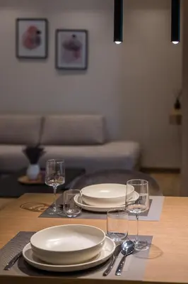 a table with plates and glasses on top of it at Amazing Stay in Athens