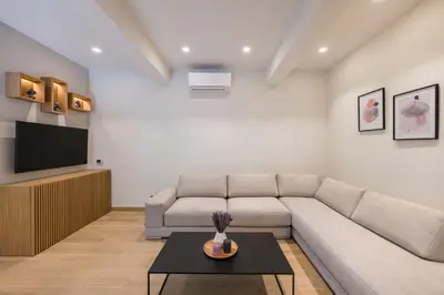a living room with a couch and a tv at Amazing Stay in Athens