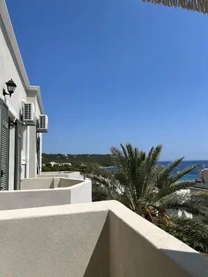 a white building with a view of the ocean at Kores Aegina in Agia Marina Aegina