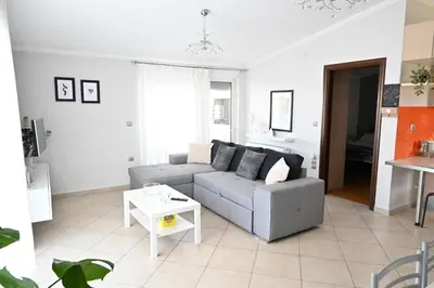 a living room with a couch and a table at Vasiliki’s Guesthouse in Athens