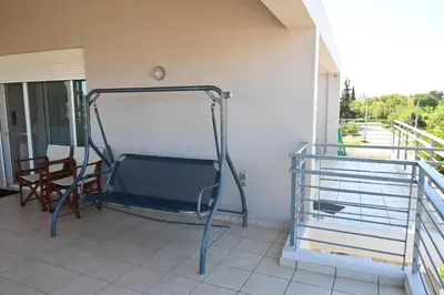 a bed in a room with a balcony at Vasiliki’s Guesthouse in Athens