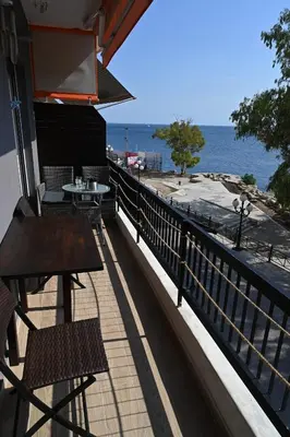 a balcony of a restaurant with a view of the ocean at Sea Luxury Apartments in Piraeus