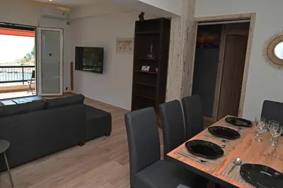 a living room with a table and a couch at Sea Luxury Apartments in Piraeus