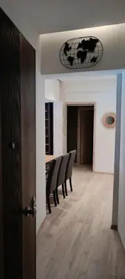 a dining room with black chairs and a table at Sea Luxury Apartments in Piraeus