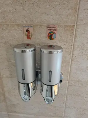 two silver coffee machines sitting on a tile wall at Apartamento Central - La Amistad in Athens
