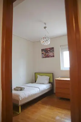 a bedroom with a bed and a dresser in it at Sunset Sea View Maisonette Anavissos in Anavissos