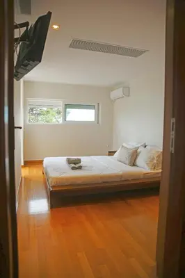 a bedroom with a large bed in a room at Sunset Sea View Maisonette Anavissos in Anavissos