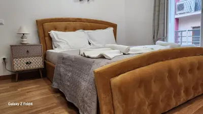 a bedroom with a bed with two brown beds at De lenco Residence 4 in Athens