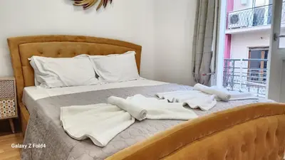 a bedroom with a bed with towels on it at De lenco Residence 4 in Athens