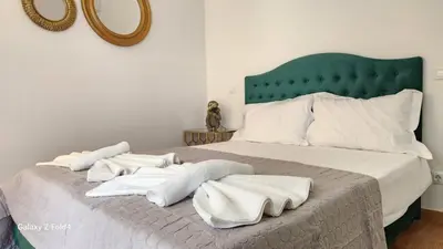 a bedroom with a bed with white towels on it at De lenco Residence 4 in Athens