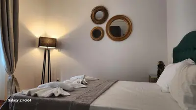 a bedroom with a bed and a mirror on the wall at De lenco Residence 4 in Athens
