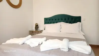 a bed with two white towels on it at De lenco Residence 4 in Athens