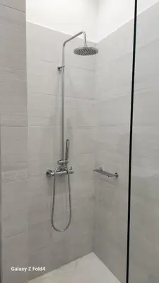 a shower with a shower head in a bathroom at De lenco Residence 4 in Athens