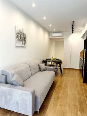 a living room with a couch and a table at Moschato New Home 3 VIPGreece in Piraeus