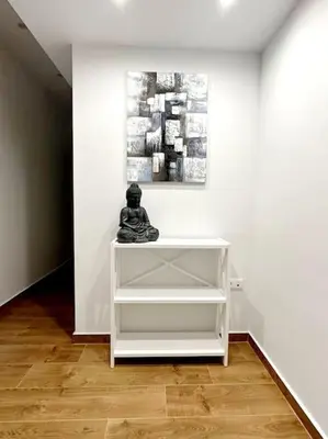 a white shelf in a white room with a sculpture on it at Moschato New Home 3 VIPGreece in Piraeus
