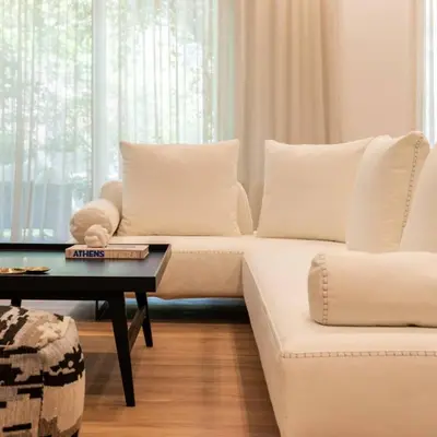 a white couch in a living room with a table at 4BD Apartment with Outdoor Jacuzzi Garden in Athens