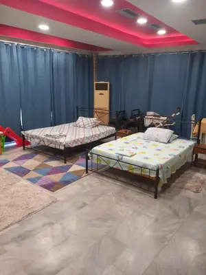 two beds in a room with blue curtains at House marios airport in Spáta