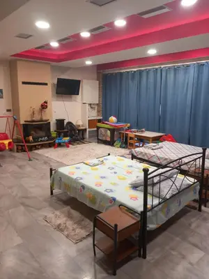 a room with two bunk beds and a flat screen tv at House marios airport in Spáta