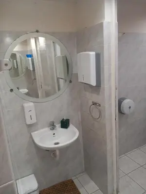 a bathroom with a sink and a mirror at House marios airport in Spáta