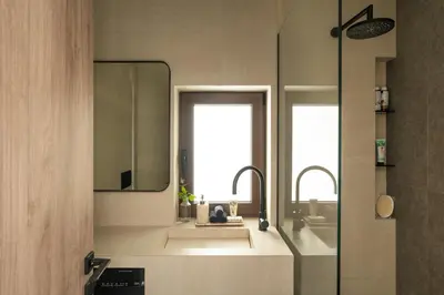a bathroom with two sinks and a mirror at Sol Residence - Private Pool Gym Glyfada in Athens