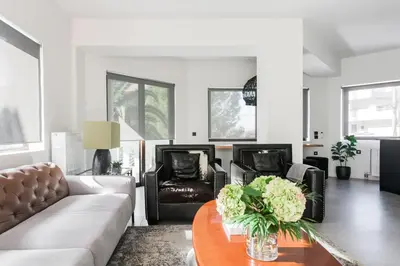 a living room with a couch and chairs and a table at Sol Residence - Private Pool Gym Glyfada in Athens