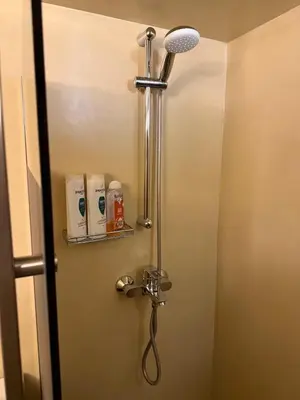 a shower in a bathroom with a shower head at Charming apartment in Glyfada in Athens