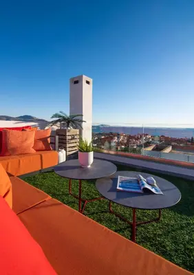 a living room with a couch and a table at Stefano's Villa Lagonissi in Lagonissi