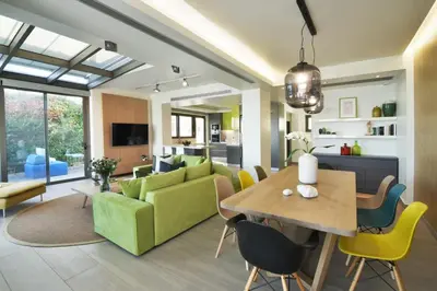 a living room with a green couch and a table at Stefano's Villa Lagonissi in Lagonissi