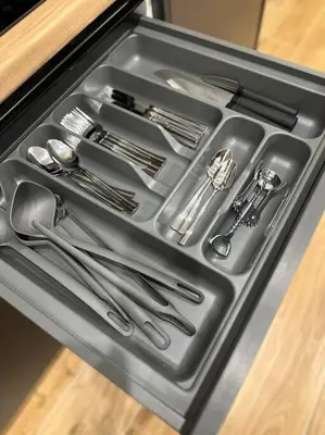 a metal tray with utensils in a drawer at Moschato Stylish Home 1 VIPGreece in Piraeus