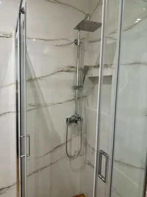 a shower with a glass door in a bathroom at Moschato Stylish Home 1 VIPGreece in Piraeus
