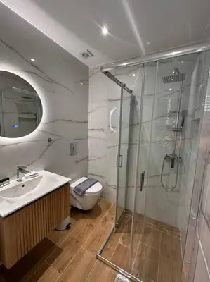 a bathroom with a shower and a sink and a toilet at Moschato Stylish Home 1 VIPGreece in Piraeus