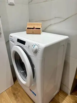a white washing machine with a box on top of it at Moschato Stylish Home 1 VIPGreece in Piraeus
