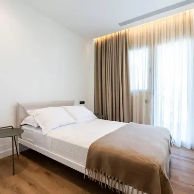 a bedroom with a white bed and a large window at 2-BD Luxury Apt Sea View Balcony near the beach in Athens