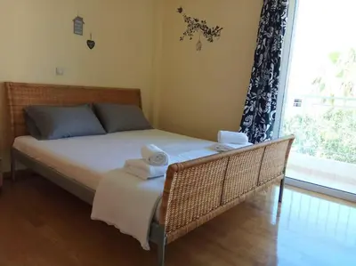 a bedroom with a bed with towels on it at Angela's Home (Near Athens Airport) in Spáta