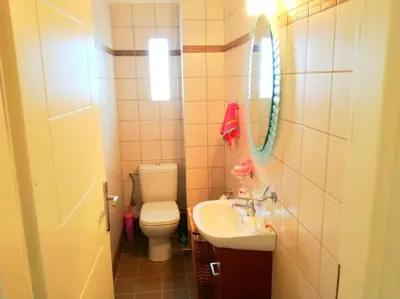 a bathroom with a toilet and a sink and a mirror at Angela's Home (Near Athens Airport) in Spáta