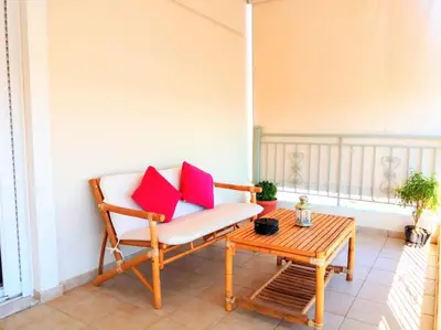 a porch with a chair and a table at Angela's Home (Near Athens Airport) in Spáta