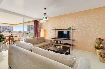 a living room with a couch and a tv at Chalandri Family Penthouse - 1' from metro station in Athens