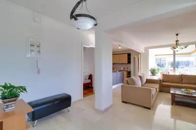 a living room with a couch and a table at Chalandri Family Penthouse - 1' from metro station in Athens