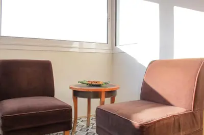 two chairs and a table in a room at Chalandri Family Penthouse - 1' from metro station in Athens