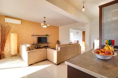 a living room with a bowl of fruit on a counter at Chalandri Family Penthouse - 1' from metro station in Athens